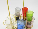 many different colored glasses in a basket on the table