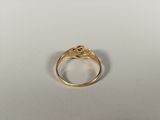 a close up of a gold ring on a white surface