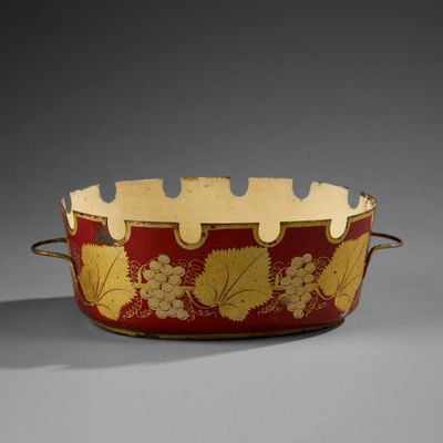 an image of a red and gold bowl with grapes on it