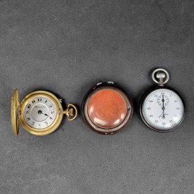 three different types of pocket watches on a table