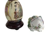 an egg and a pig figurine sitting next to each other