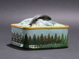 a small box with a snake on top of it