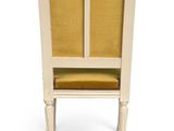 an image of a white chair with yellow upholstered seat