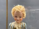 une poupée aux cheveux blonds dans une vitrine
