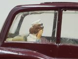 a toy figurine of a woman in a car