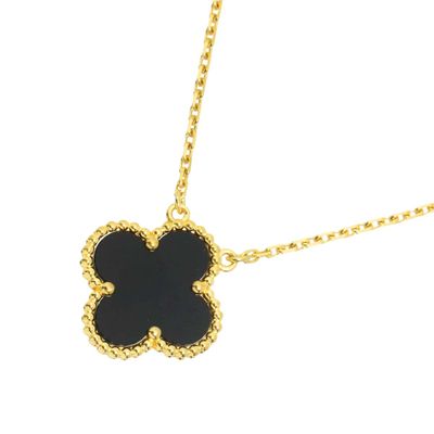 a black and gold necklace with a flower on it