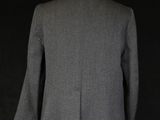 the back view of a grey jacket on a mannequin mannequin