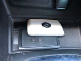 an image of a cell phone in the center console of a car