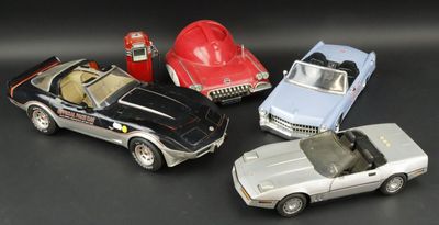 several toy cars are lined up in a row on a black surface