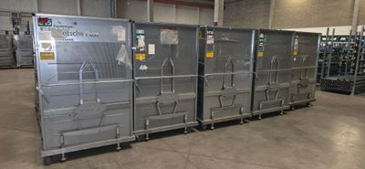 many metal boxes that are stacked up in a warehouse