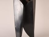 an image of a metal sculpture on a stand on a white background