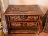 a small wooden table with a drawer on top of it