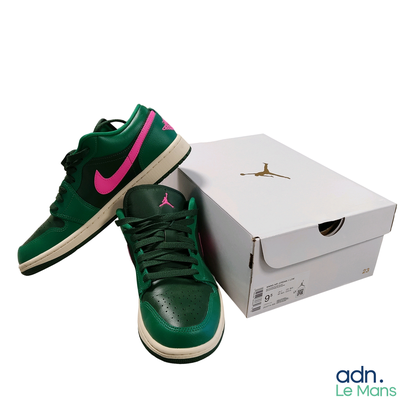a pair of green and pink shoes next to a box