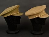 two hats on a black mannequin head on a black background