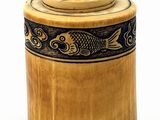 a wooden box with a fish design on it