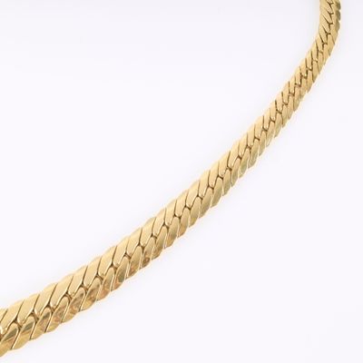 a close up of a gold chain on a white background