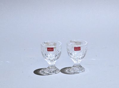 two empty wine glasses sitting on a white surface
