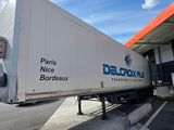 a semi truck that is parked in front of a gas station