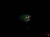 an image of a green and red fire oplite in the dark