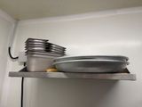 a metal shelf with a bowl and pans on it