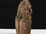 a close up of a sculpture of a person sitting on a rock