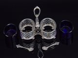 three glasses and a candle holder on a black table