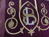 a purple and gold blanket with a monogram on it