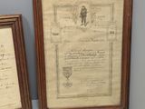 two framed pictures on the wall of a room