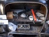 an old car with a lot of junk in it