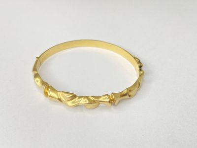 a close up of a gold ring on a white surface
