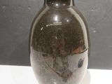 a brown vase sitting on a white table
