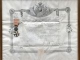 un vieux document sur lequel figure une médaille
