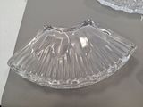 a clear glass bowl sitting on a table next to a pair of scissors