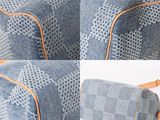 a close up of a blue and white checkered bag with a brown strap