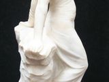 a statue of a woman holding a basket of flowers