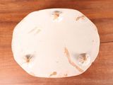 an overhead view of a white plate on a wooden table