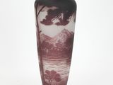a vase that has a picture of a mountain scene on it
