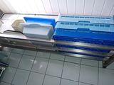a picture of a metal table with plastic containers on top of it