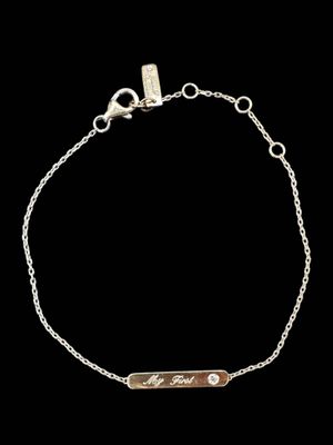 a silver bracelet with a bar on a chain