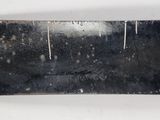 an image of a black metal plate with a hole in it