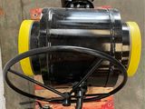 an image of a black and yellow tank on a pallet