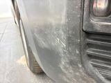 a close up of a car ' s front bumper with scratches on it
