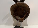 sculpture of a baseball helmet with a baseball bat sticking out of it ' s mouth