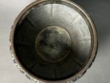 a close up of a metal bowl on a table