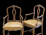 paire de chaises en bois sculpté avec des assises rembourrées de cuir