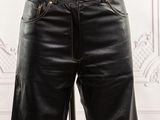 a mannequin wearing a pair of black leather pants