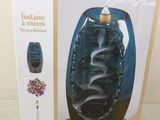 packaging of a blue glass vase with a wooden stand