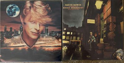 two cd ' s of david bowie ' s last album are on the floor