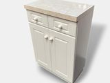 a white cabinet with two drawers and a counter top