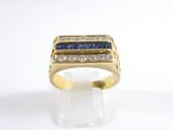 gros plan d'une bague en or avec saphirs bleus et diamants
